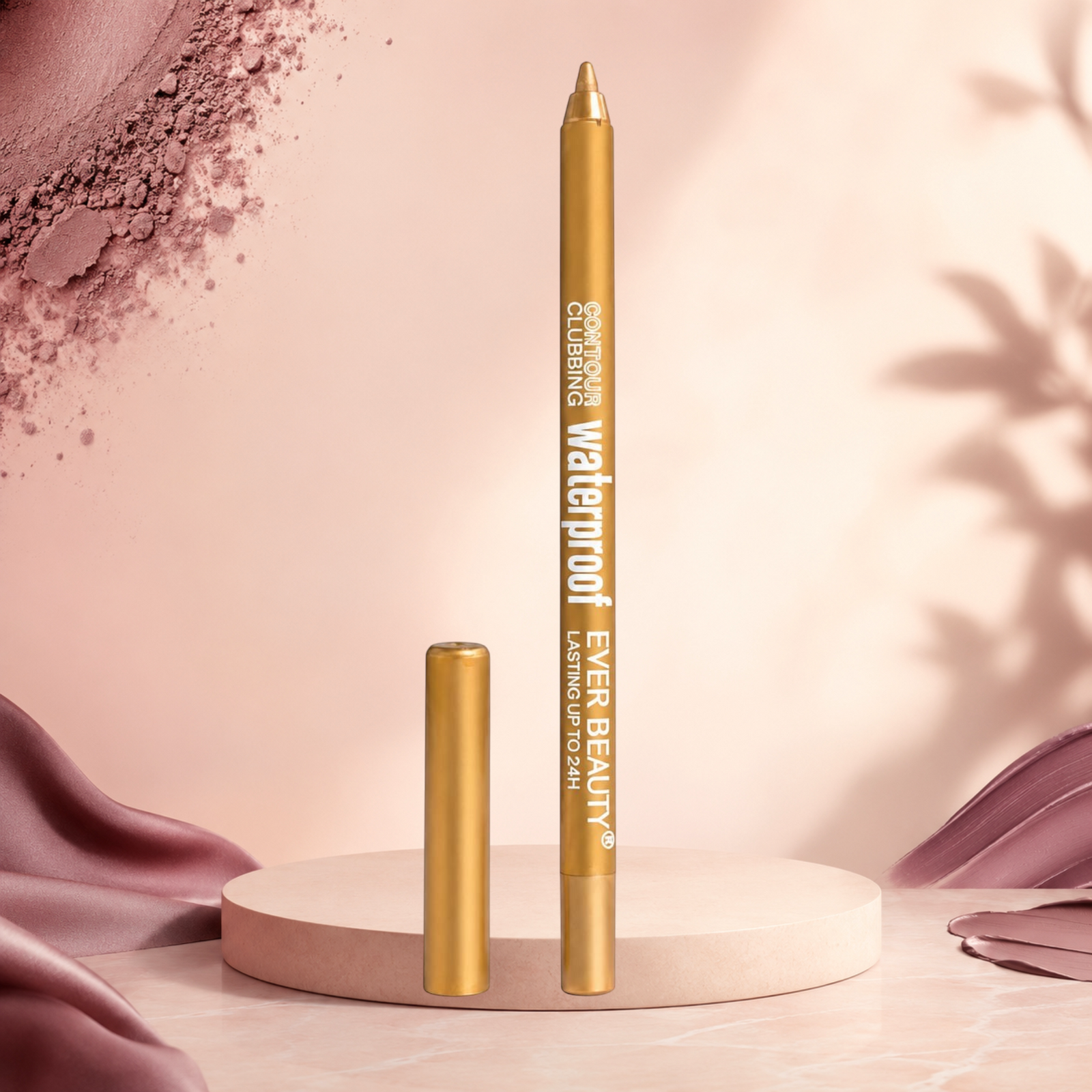 Marom EVER BEAUTY waterproof gold eye contour pencil standing on a circular pedestal with soft pink fabric background